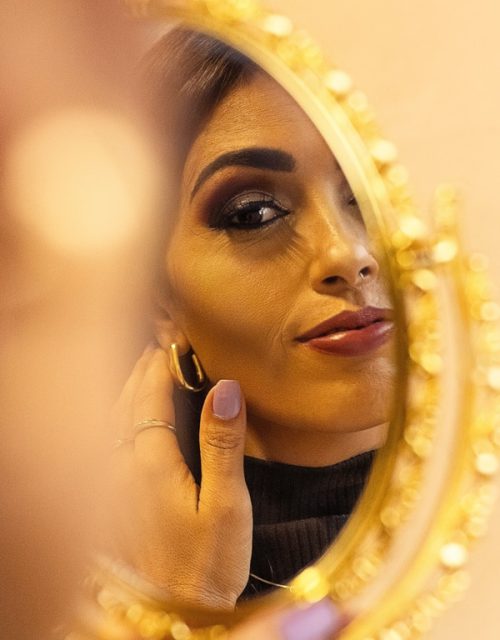 Woman looking into mirror