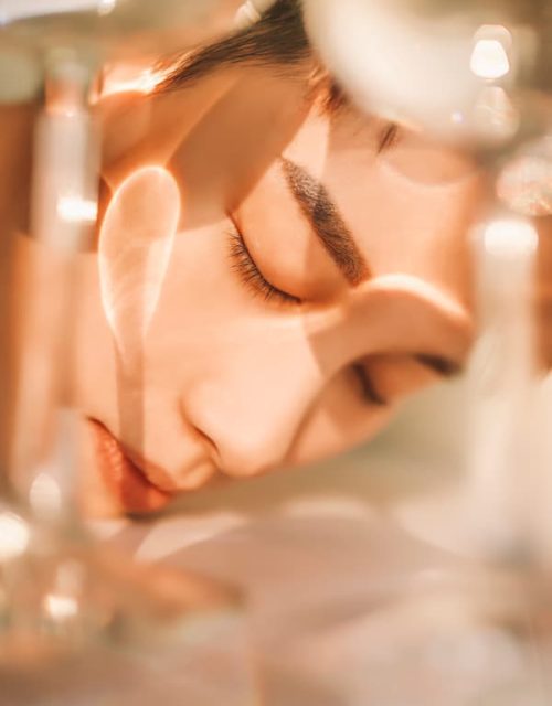 Woman looking into mirror